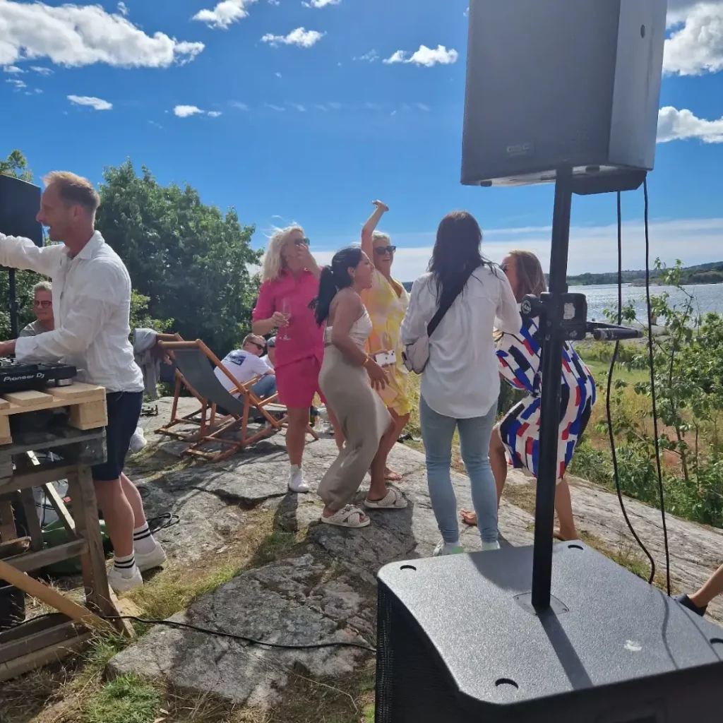 Tjejer som dansar på berget, solsken, hav, musik och härlig stämning.
